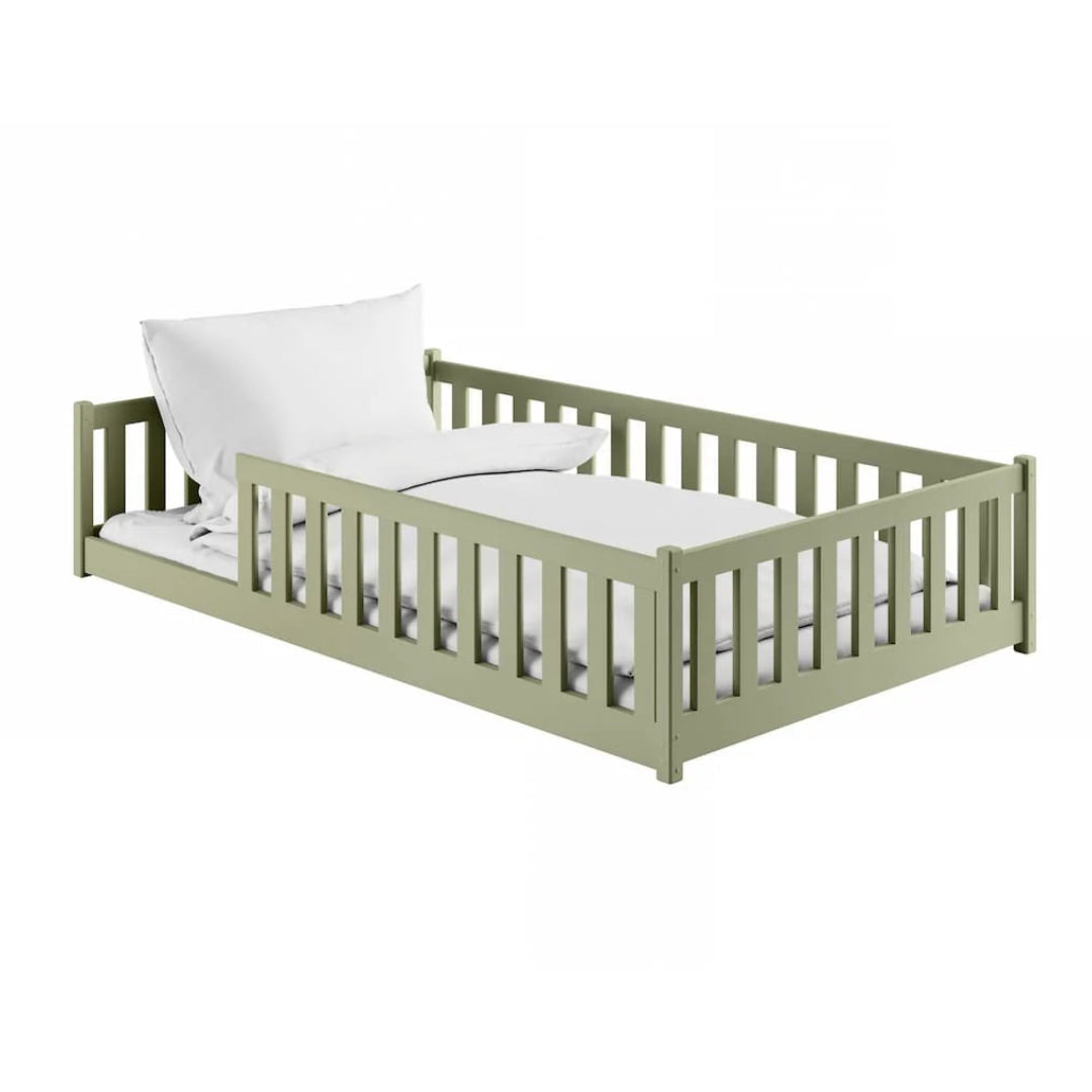 Green children's bed with white bedding on a white background