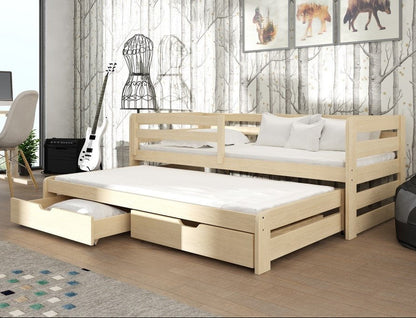 Wooden bed with pull-out trundle in a room with a guitar, chair, and decor.