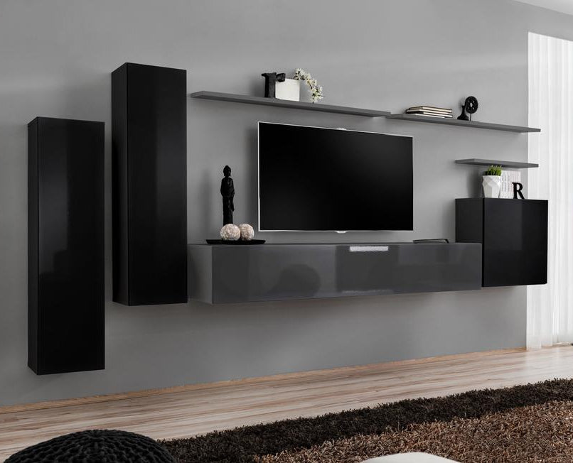 Modern living room with black and gray wall unit, TV, and decor.
