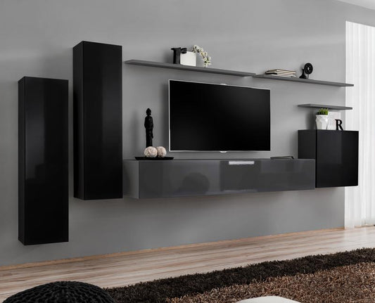 Modern living room with black and gray wall unit, TV, and decor.