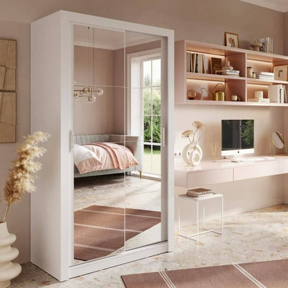 Modern bedroom with a wardrobe, desk, and chair.