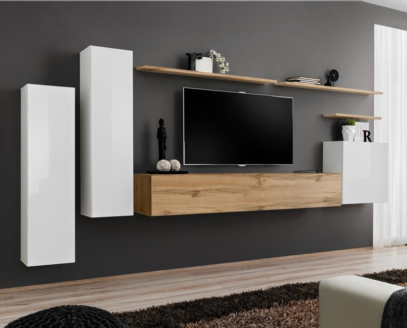 Modern living room with a TV unit against a gray wall, featuring wooden and white furniture.