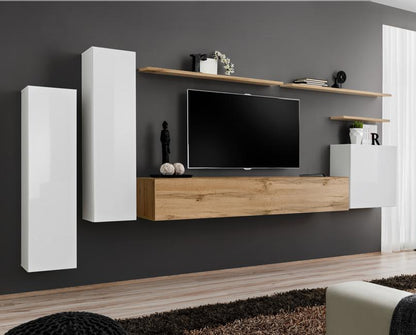 Modern living room with a TV unit against a gray wall, featuring wooden and white furniture.