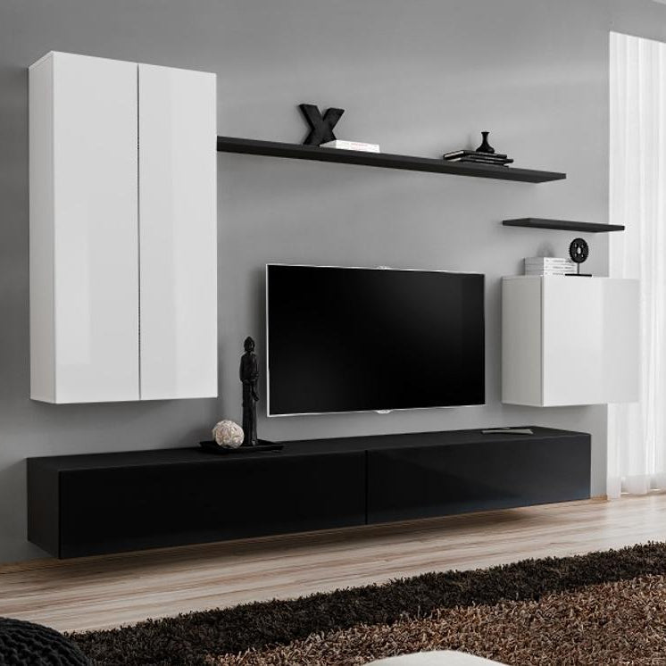 Modern living room with black and white furniture, including a TV stand and wall-mounted cabinets.