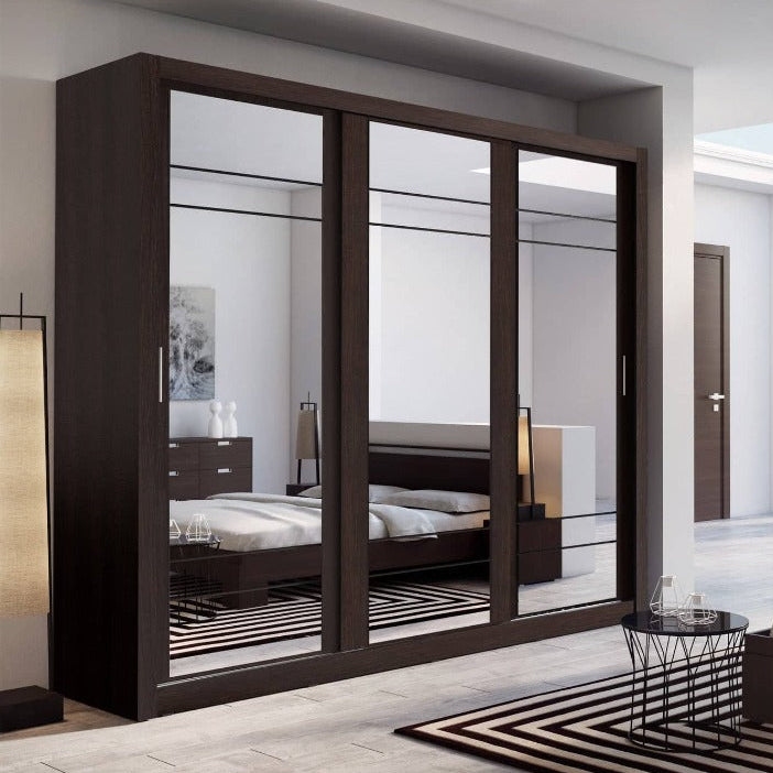 Modern bedroom with a large mirror wardrobe and bed.