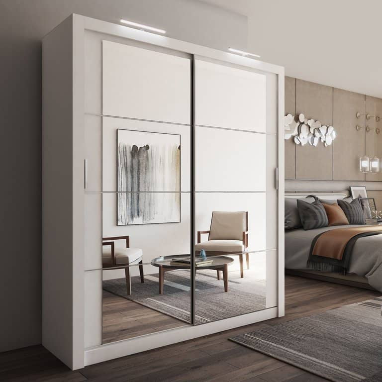 Modern bedroom with a wardrobe, bed, and chairs.