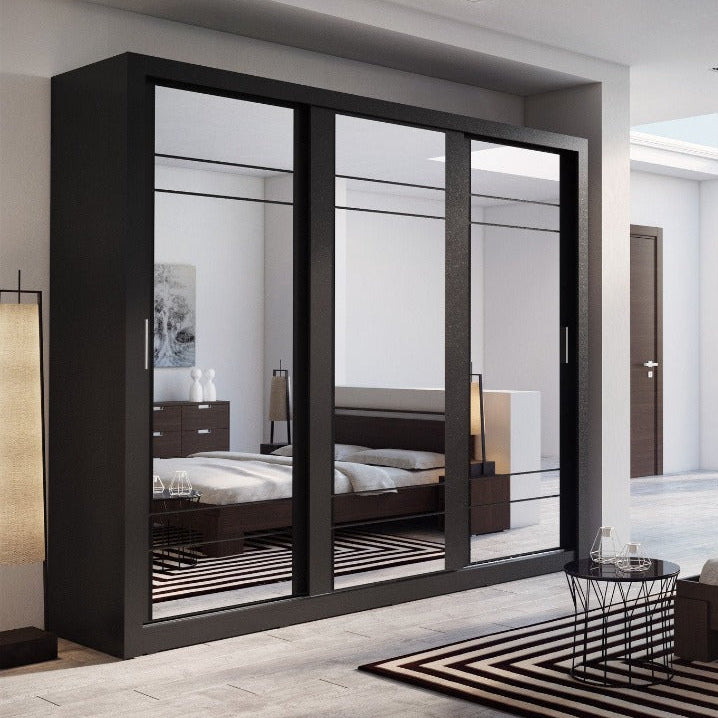 Modern bedroom with a large black wardrobe and bed.