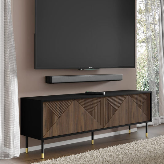 TV mounted on a wall with a wooden TV stand below in a room with curtains.