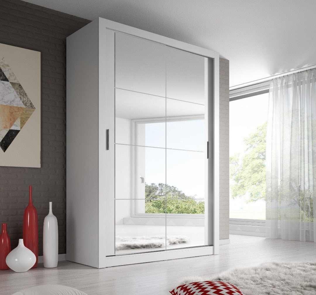 Modern white wardrobe with glass doors in a room with a window and decorative vases.