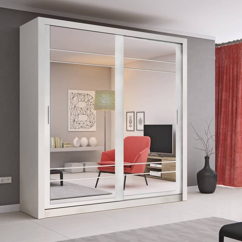 Modern interior with a white wardrobe with sliding glass doors, red armchair, and gray walls.