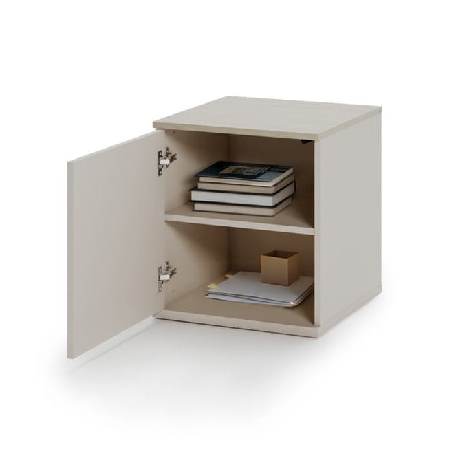 Small beige cabinet with open door on a white background