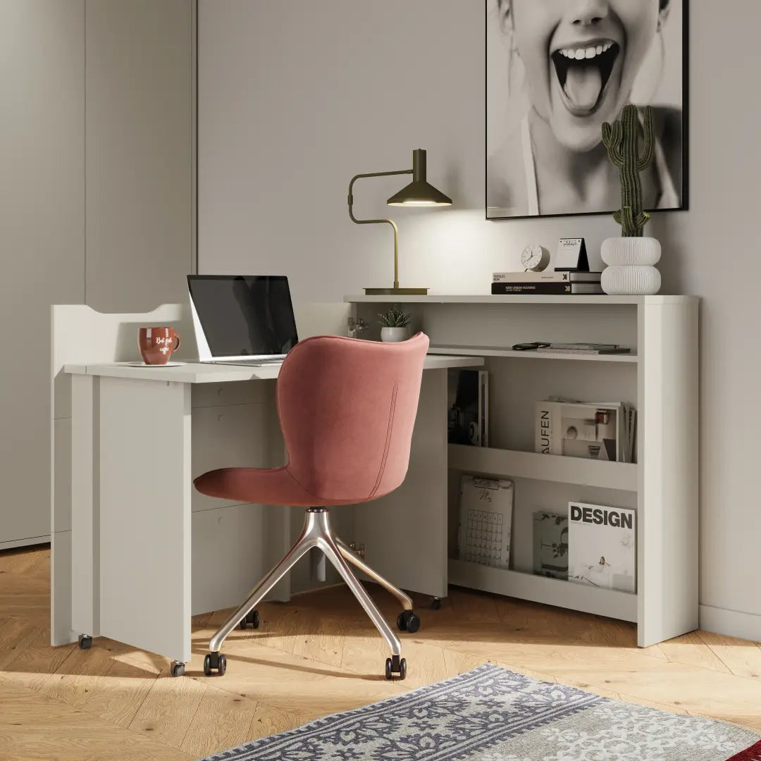 Modern home office with a white desk, pink chair, and decorative items.