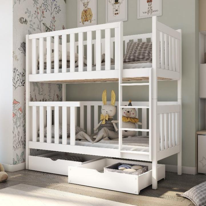 White children's bunk bed with storage drawers in a room setting.
