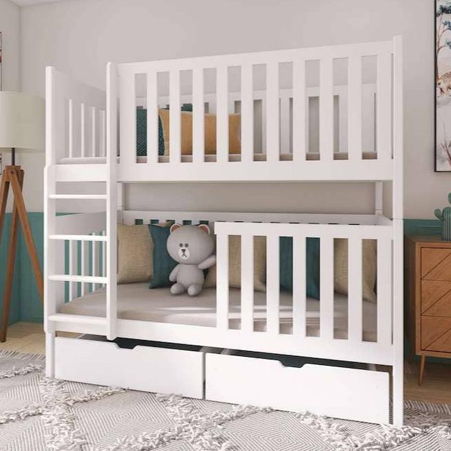 White bunk bed with a teddy bear on a cushion in a room setting.