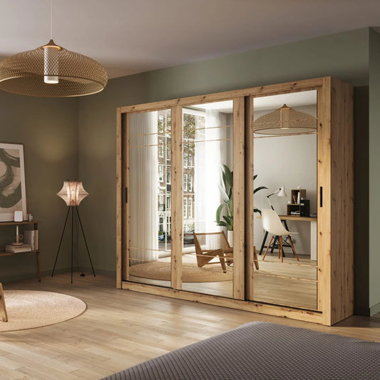 Large wooden wardrobe with mirrors in a room with a lamp and plant.