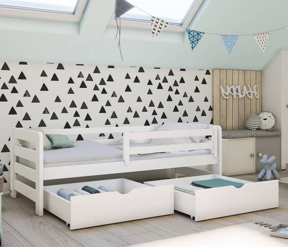 Children's bedroom with a white bunk bed, storage drawers, and decorative elements.