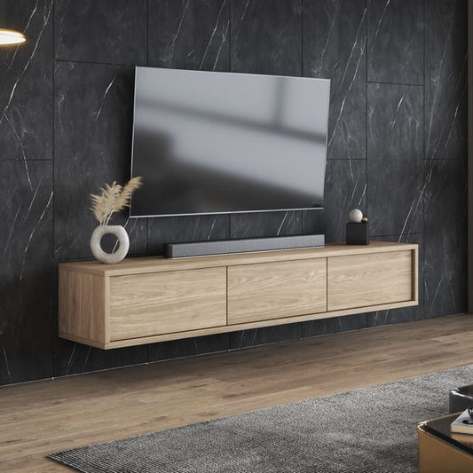 Modern living room with a television on a wooden stand against a dark marble wall.