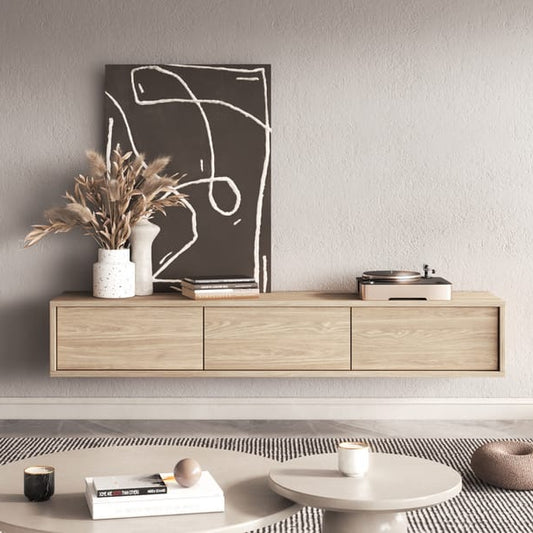 Modern living room with wooden cabinet, plants, and decor items.