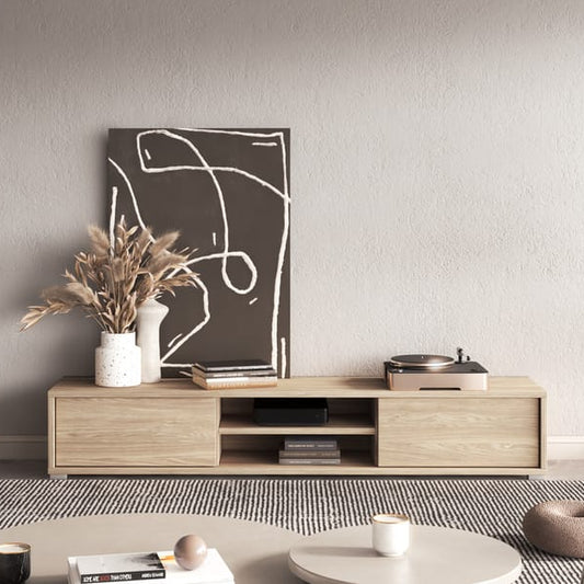 Modern living room with a wooden TV stand, white sofa, and decorative items.