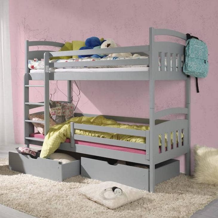 Gray bunk bed with toys and a backpack in a room with pink walls.