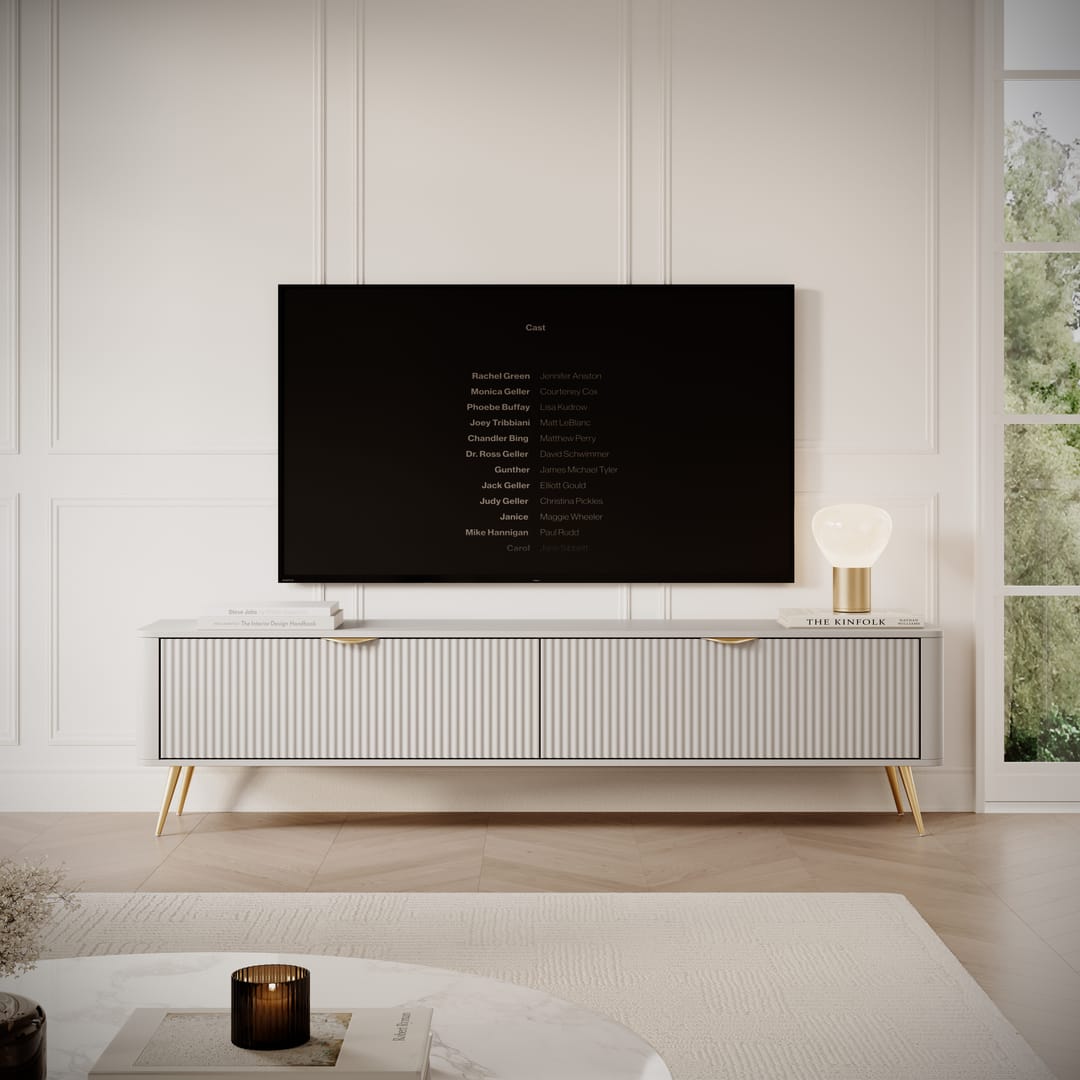 Modern living room with a flat-screen TV mounted on the wall above a white cabinet.