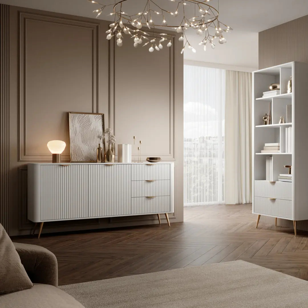 Modern living room with white sideboard, bookshelf, and decorative items.