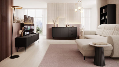 Modern living room with a beige sofa, coffee table, and decorative items.