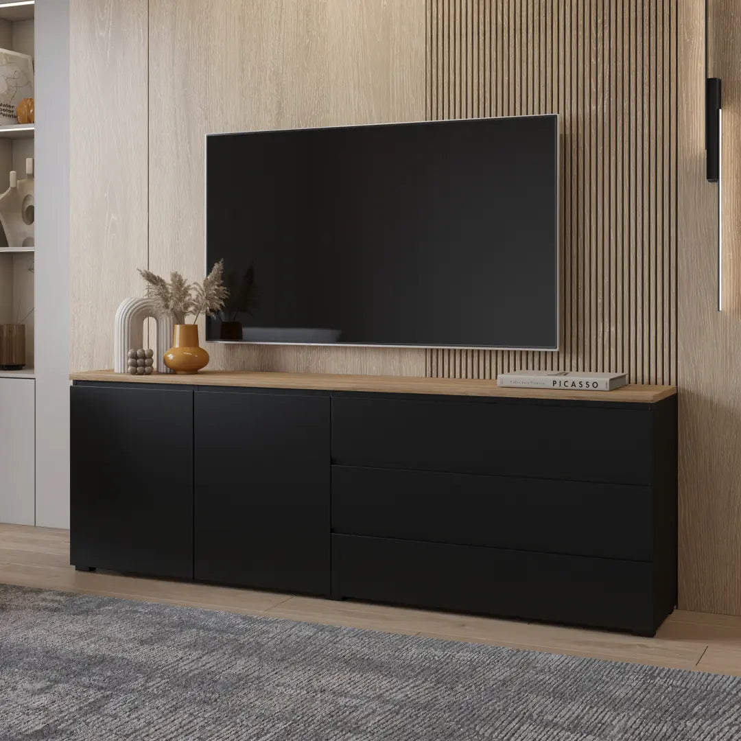 Black entertainment console with a TV above it in a room with wooden walls.
