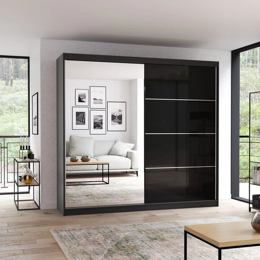 Modern black sliding wardrobe door in a room with a sofa and decor.