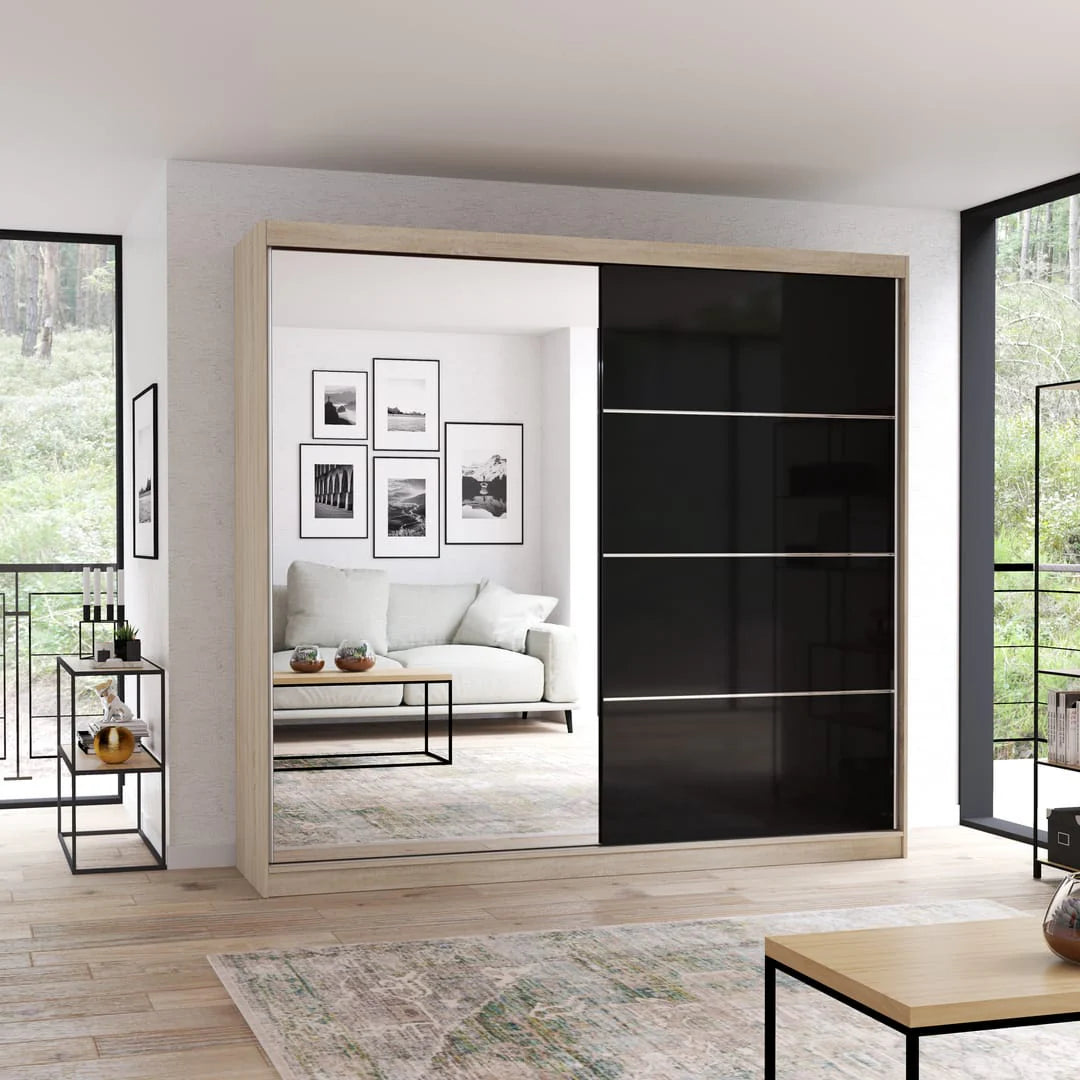 Modern sliding wardrobe with black glass panels in a living room setting