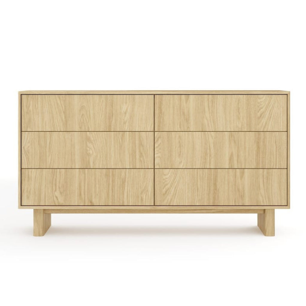 Wooden dresser with four drawers on a white background