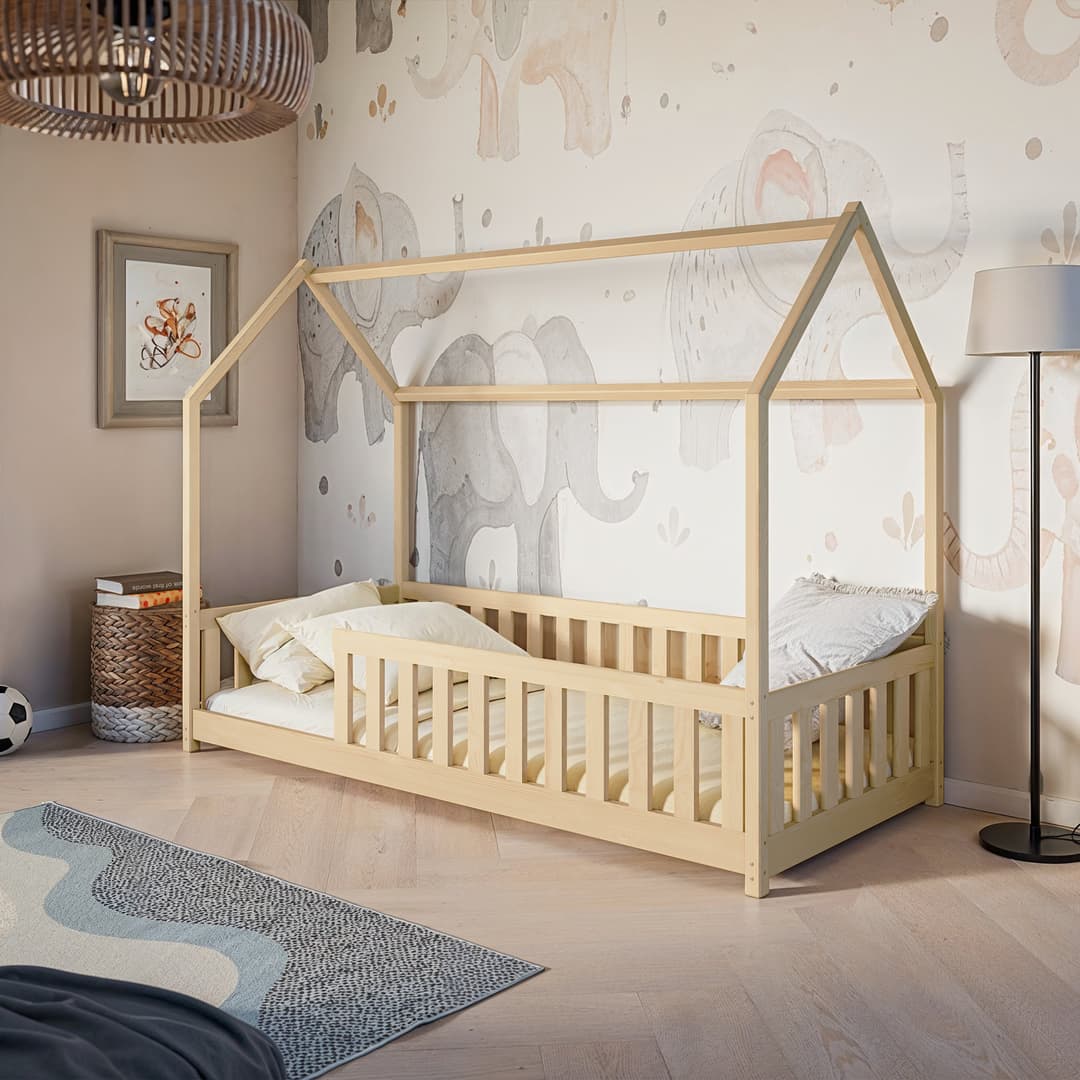 Children's room with a wooden house-shaped bed, elephant wallpaper, and decorative items.