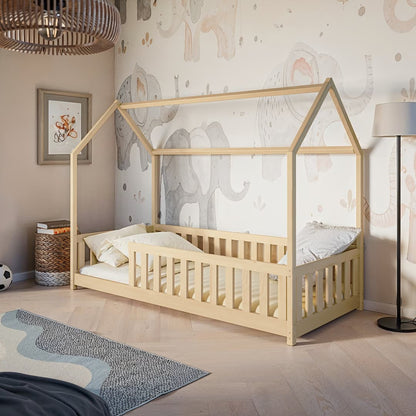 Children's room with a wooden house-shaped bed, elephant wallpaper, and decorative items.