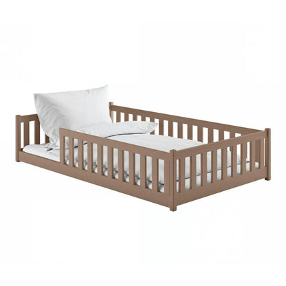 Wooden children's bed with white mattress and pillow on a white background