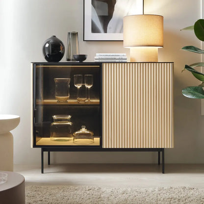 Modern cabinet with glass doors displaying decorative items in a stylish interior setting.