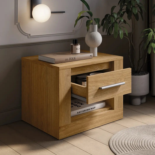 Wooden nightstand with open drawer in a room setting with decor elements.