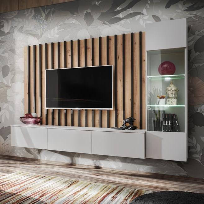 Modern living room setup with a TV mounted on a wooden panel and shelves below.