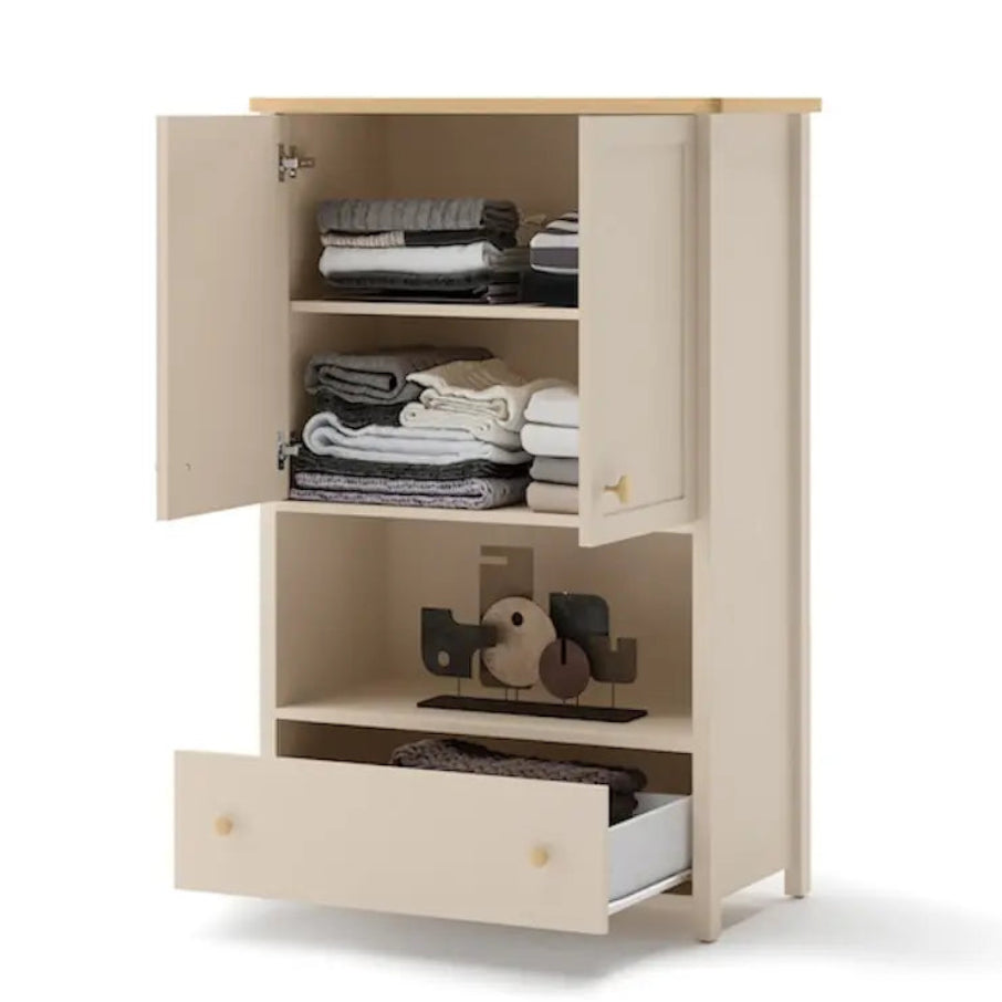 Beige wardrobe with open doors and a drawer, containing folded clothes and a duck-shaped object on a white background.