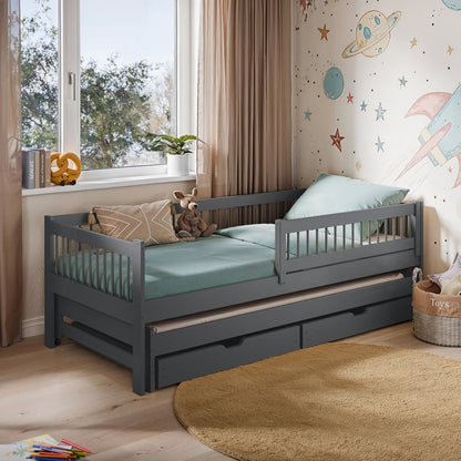 Children's bedroom with a gray bed with trundle, teddy bear, and space-themed wallpaper.