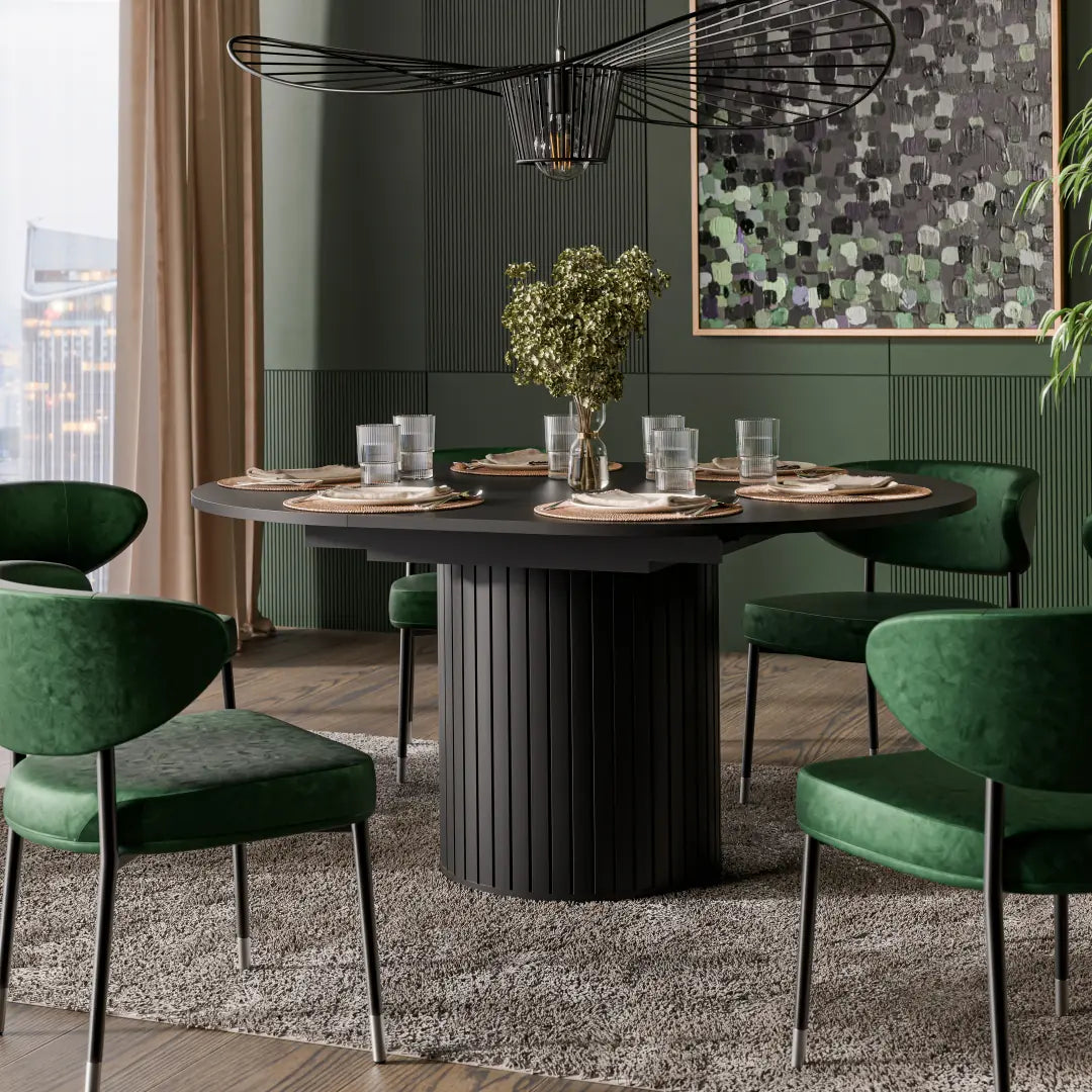 Modern dining room with a black round table and green chairs, featuring a cityscape view.