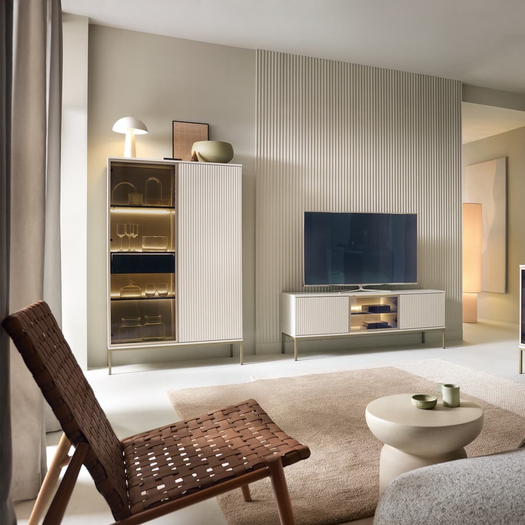 Modern living room with a television, cabinet, and decorative items.