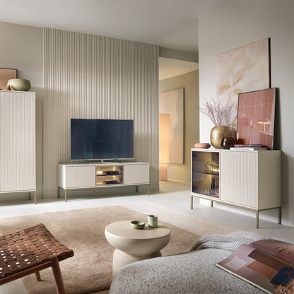 Modern living room with a television on a stand, sideboard, and decor items.