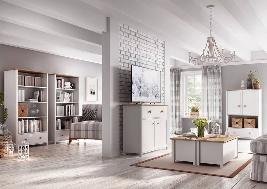 Modern living room with white furniture, bookshelves, and a television.