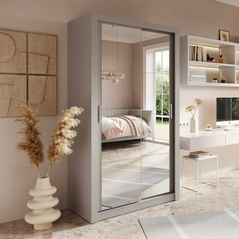 Modern home office with a sliding door leading to a bedroom.