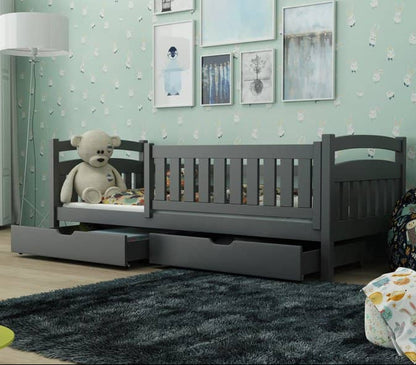 Children's room with a gray crib, teddy bear, and decorative elements.