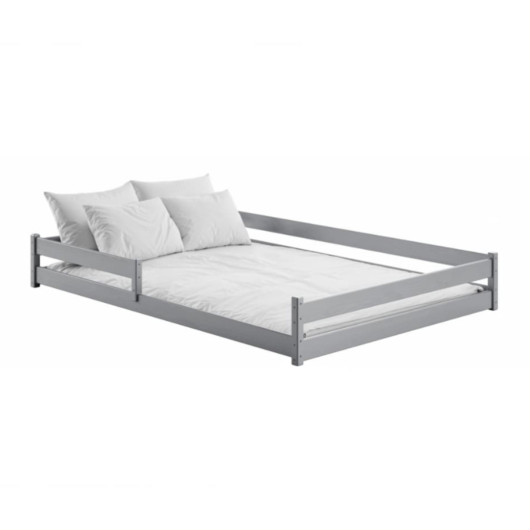 Gray bed frame with white mattress and pillows on a white background