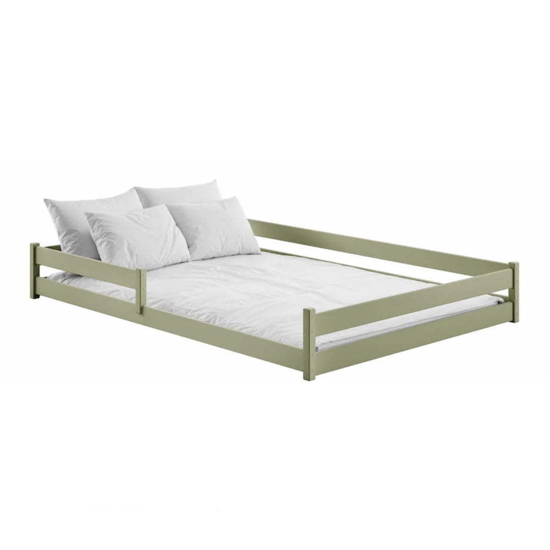 Green bed frame with white bedding on a white background
