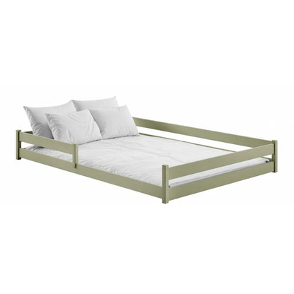 Green bed frame with white bedding on a white background