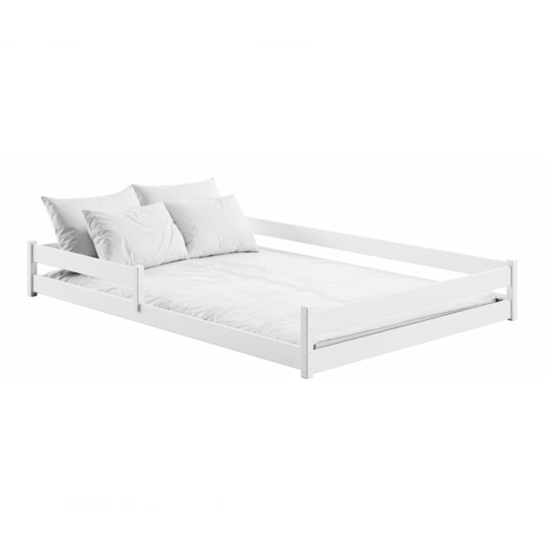 White bed frame with white bedding on a white background