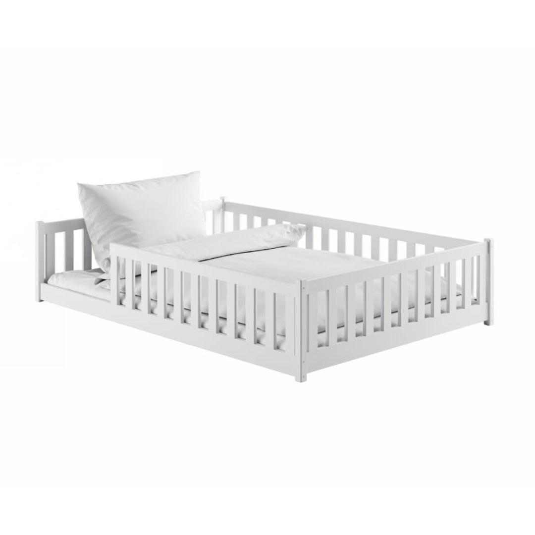 White crib with a white mattress on a white background